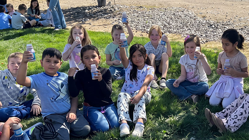 KidsMilkUpscaled_806x453px.jpg Students participating in a dairy education program about farming and milk production